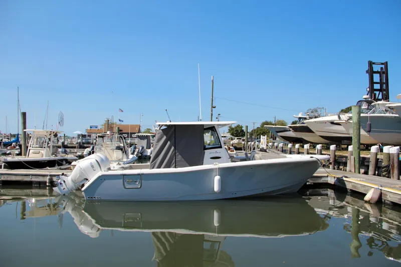 Slide: The Image of 2025 Sea Hunt Gamefish 28 boat docked in a marina under clear blue skies. - 6