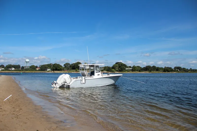 Slide: The Image of Sea Hunt Gamefish 28 boat anchored near sandy shore, 2025 model. - 7