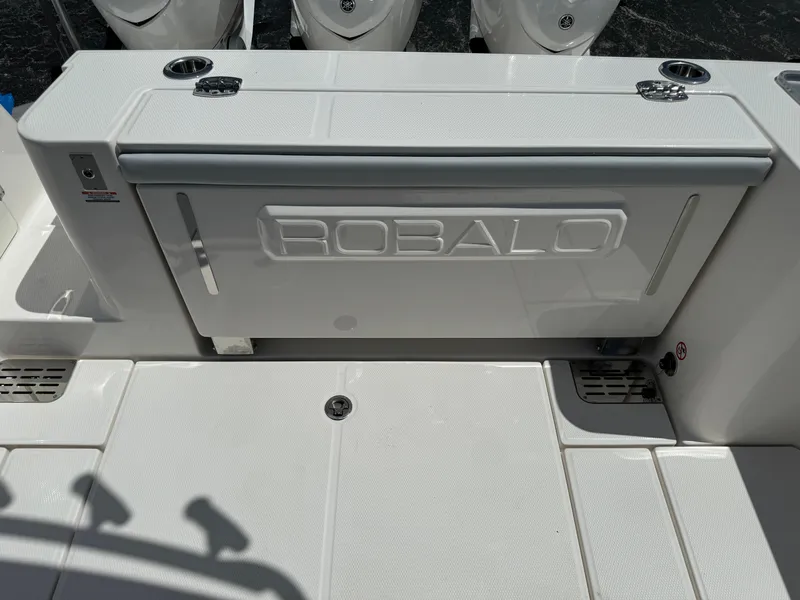 Slide: The Image of 2025 Robalo R360 Center Console boat deck with storage compartment. - 10