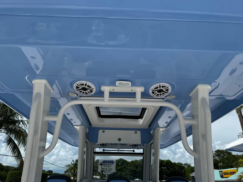 Slide: The Image of 2025 Robalo R360 Center Console boat interior with blue ceiling and speakers. - 15