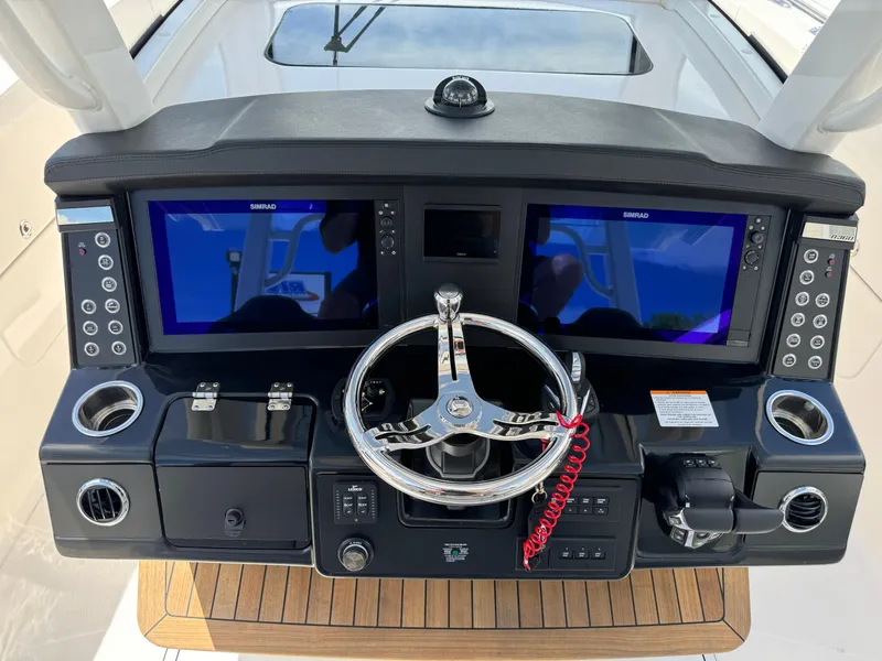 Slide: The Image of 2025 Robalo R360 Center Console dashboard with dual screens and modern controls. - 19