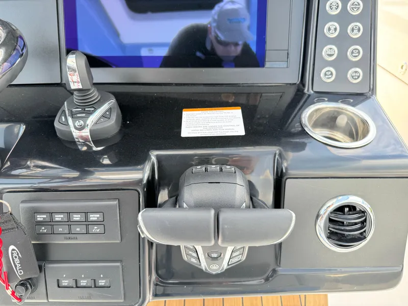 Slide: The Image of 2025 Robalo R360 Center Console dashboard with controls and display screen. - 22