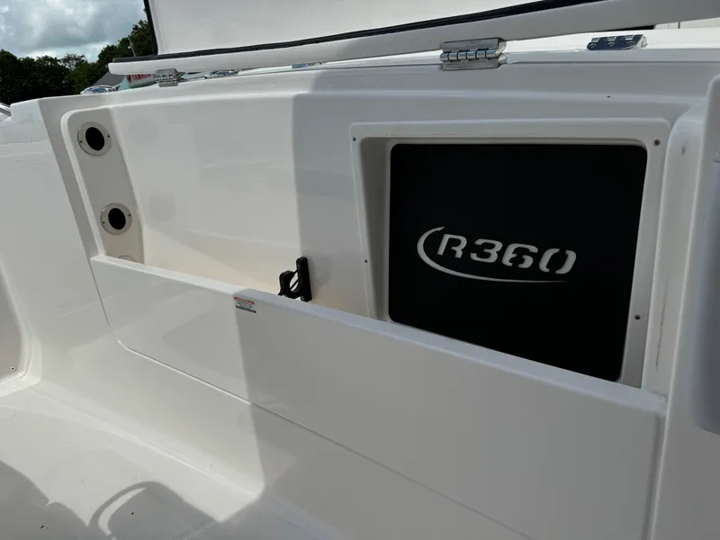 Slide: The Image of 2025 Robalo R360 Center Console boat interior detail with storage compartment. - 32