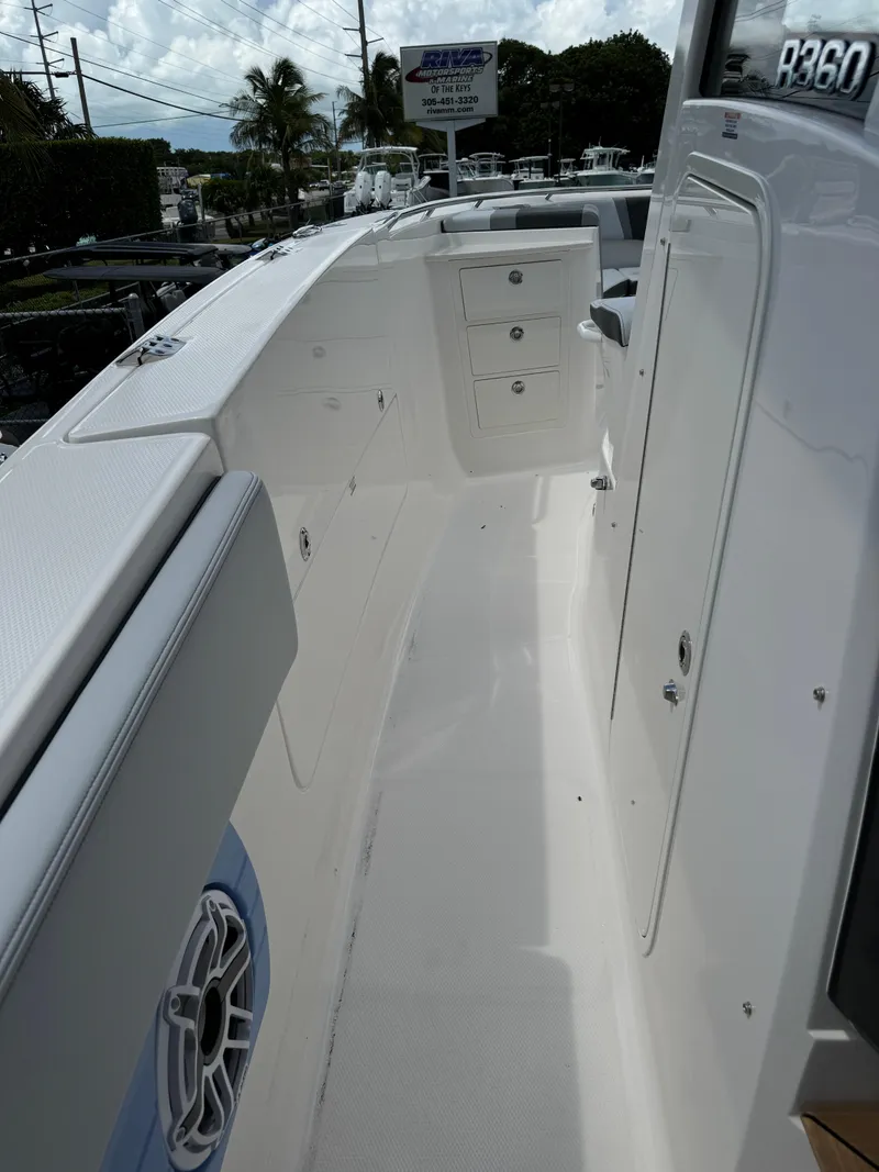 Slide: The Image of 2025 Robalo R360 Center Console boat interior with storage compartments. - 33