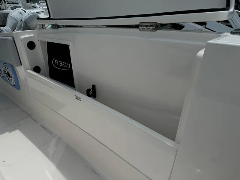 Slide: The Image of 2025 Robalo R360 Center Console boat interior with storage compartment. - 34
