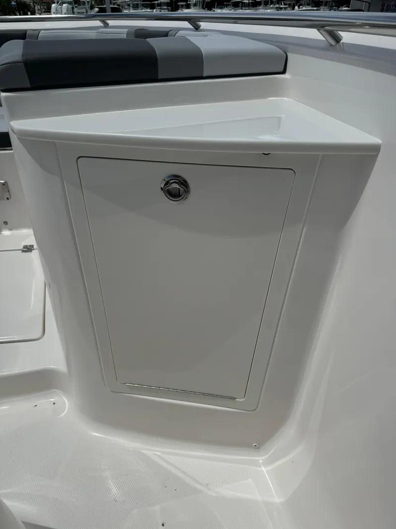 Slide: The Image of 2025 Robalo R360 Center Console boat storage compartment with sleek design. - 38