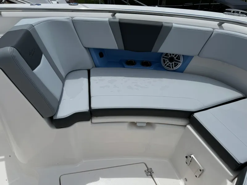 Slide: The Image of 2025 Robalo R360 Center Console boat seating area with cushioned seats and speaker. - 44