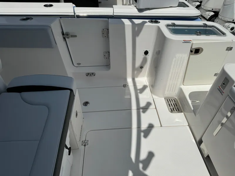 Slide: The Image of 2025 Robalo R360 Center Console boat interior, featuring seating and storage compartments. - 9