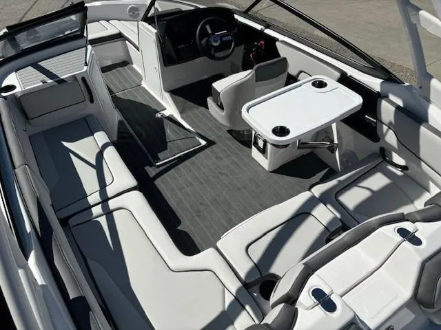 Slide: The Image of 2025 Yamaha Boats AR190 interior with seating, steering console, and table setup. - 10