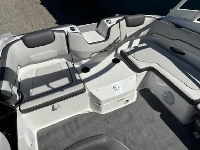 Slide: The Image of 2025 Yamaha Boats AR190 interior seating with gray upholstery and cup holders. - 13
