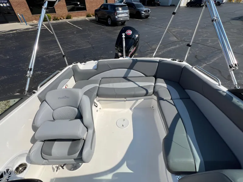Slide: The Image of 2023 NauticStar 203 DC boat interior with gray seating and outboard motor. - 10