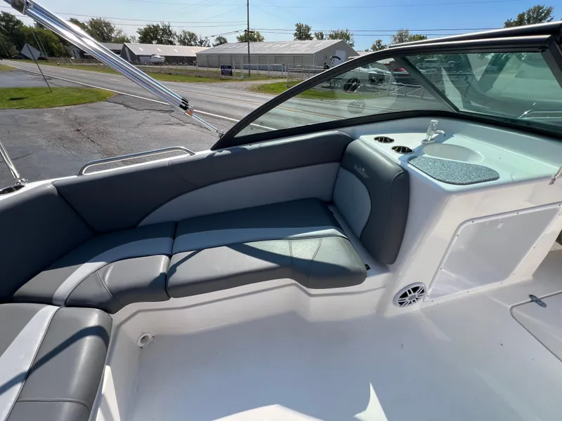 Slide: The Image of 2023 NauticStar 203 DC boat interior with gray seating and modern design. - 15