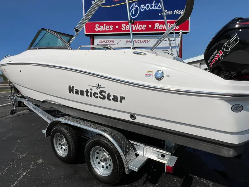 Slide: The Image of 2023 NauticStar 203 DC boat on trailer at dealership. - 3