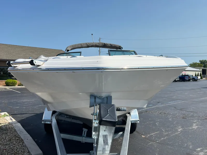 Slide: The Image of 2023 NauticStar 203 DC boat on trailer in parking lot, front view. - 5