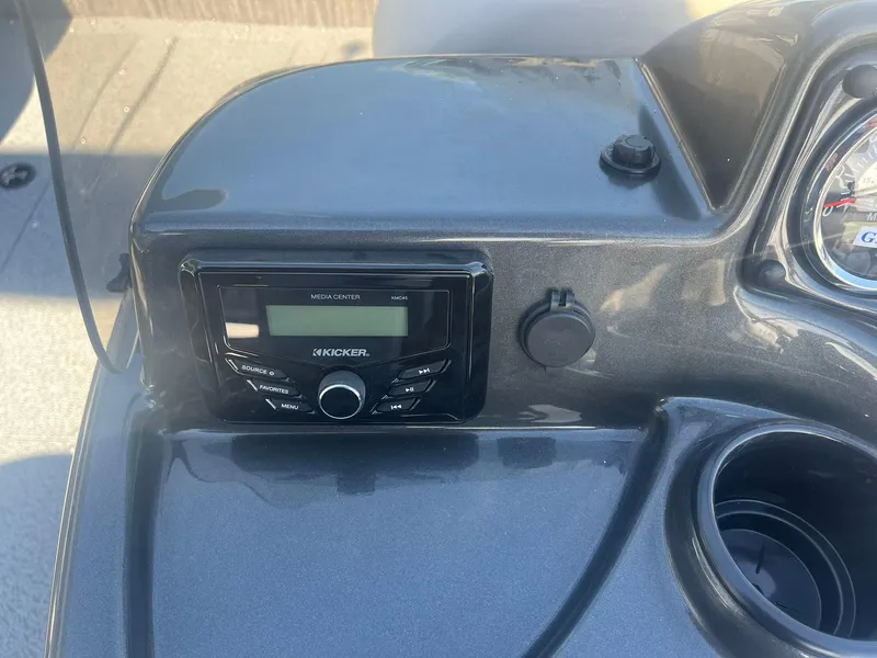 Slide: The Image of 2025 Lowe Deck SD224 boat dashboard with Kicker stereo system and cup holder. - 20