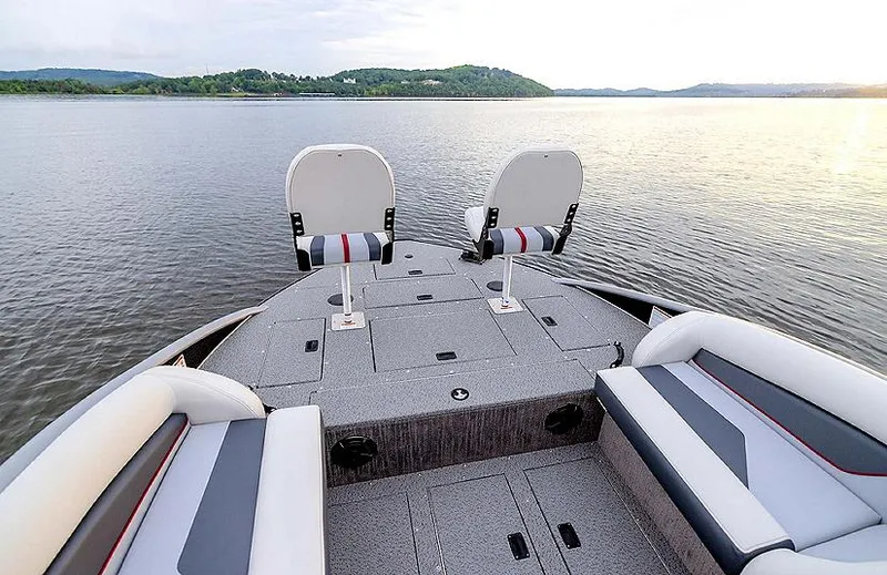 Slide: The Image of 2025 Lowe Deck SD224 boat on serene lake with seating and storage. - 36