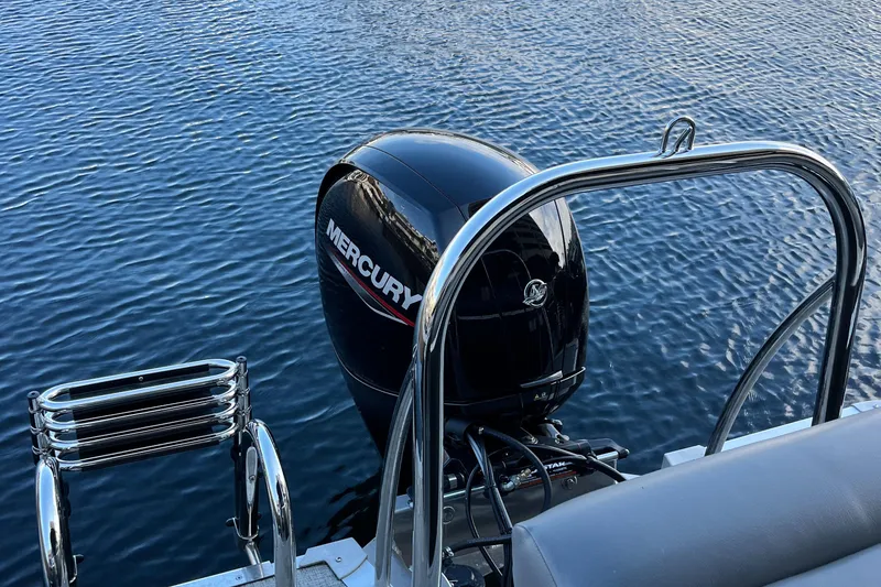 Slide: The Image of 2023 Tahoe Pontoon LTZ Cruise with Mercury outboard motor on calm water. - 15