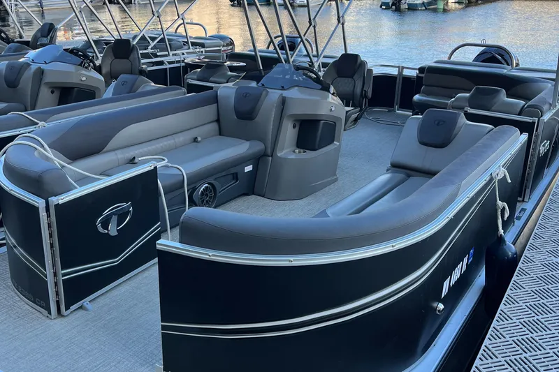 Slide: The Image of 2023 Tahoe Pontoon LTZ Cruise boat with sleek seating and modern design on the water. - 9