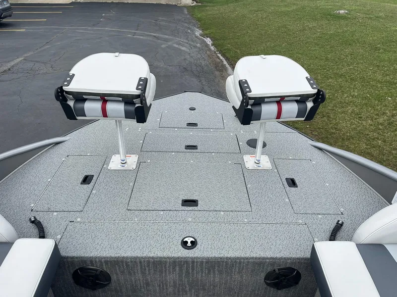 Slide: The Image of 2025 Lowe Deck SD224 boat with dual swivel seats on a gray deck. - 11