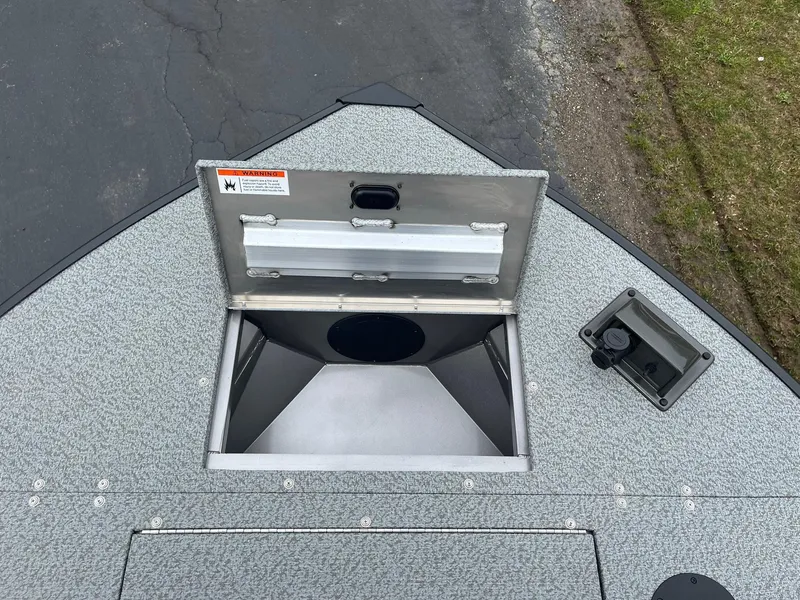 Slide: The Image of 2025 Lowe Deck SD224 boat storage compartment with open lid, showing interior space. - 15