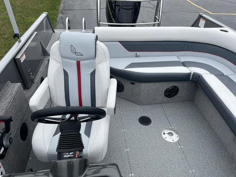 Slide: The Image of 2025 Lowe Deck SD224 boat interior with gray and white seating and steering wheel. - 20