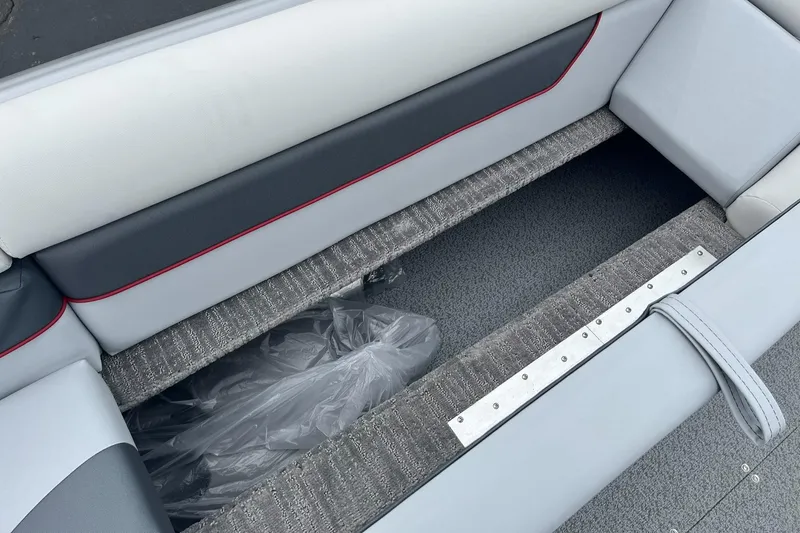 Slide: The Image of 2025 Lowe Deck SD224 boat interior with gray seating and storage compartment. - 24