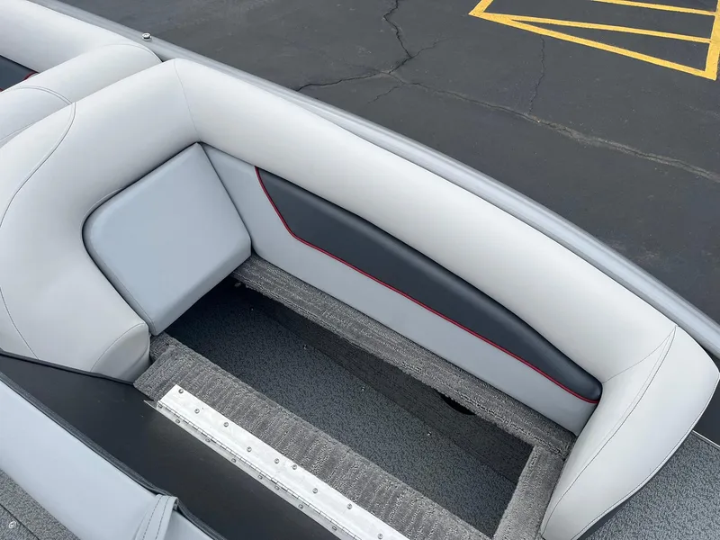 Slide: The Image of 2025 Lowe Deck SD224 boat interior with gray and black seating, red accent stitching. - 28