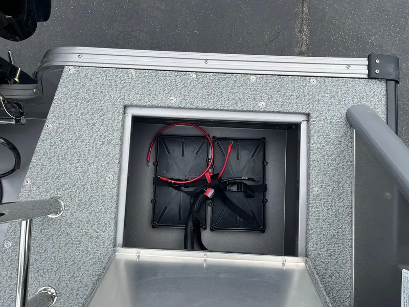 Slide: The Image of Battery compartment of a 2025 Lowe Deck SD224 boat with visible wiring. - 35