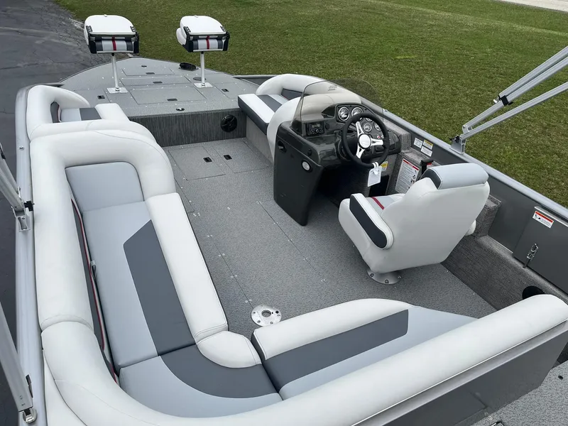 Slide: The Image of 2025 Lowe Deck SD224 boat interior with plush seating and modern helm. - 7