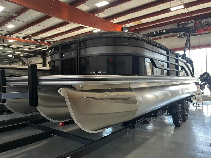 The Image of 2025 Lowe SS 230 WV pontoon boat in showroom, sleek design, metallic finish. - 0