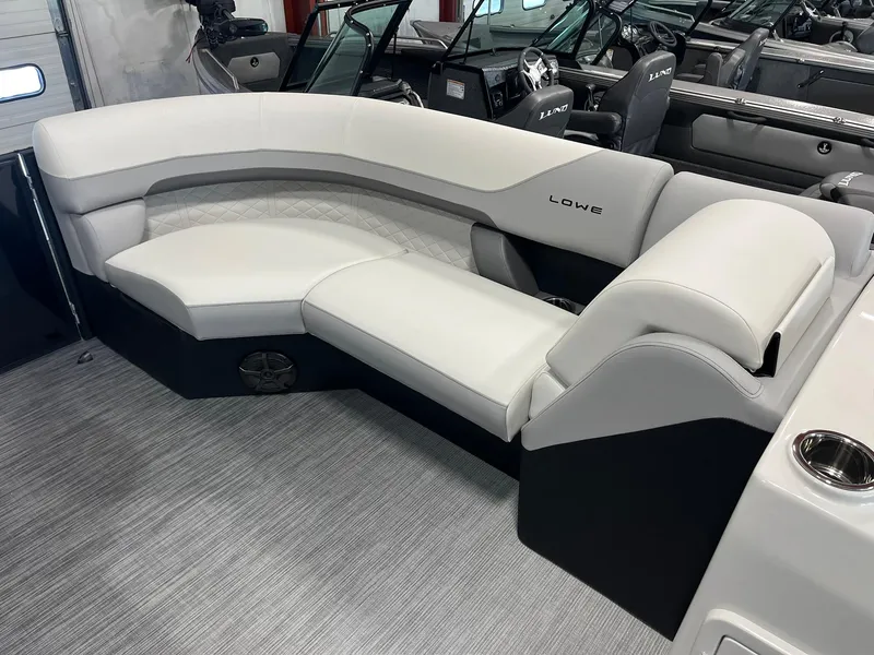 Slide: The Image of 2025 Lowe SS 230 WV boat interior with white cushioned seating. - 17
