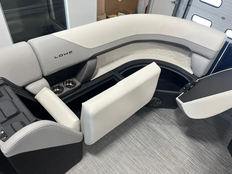 Slide: The Image of 2025 Lowe SS 230 WV boat interior with plush seating and storage compartments. - 19