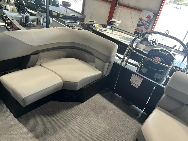 Slide: The Image of 2025 Lowe SS 230 WV boat interior with plush seating and modern steering console. - 22