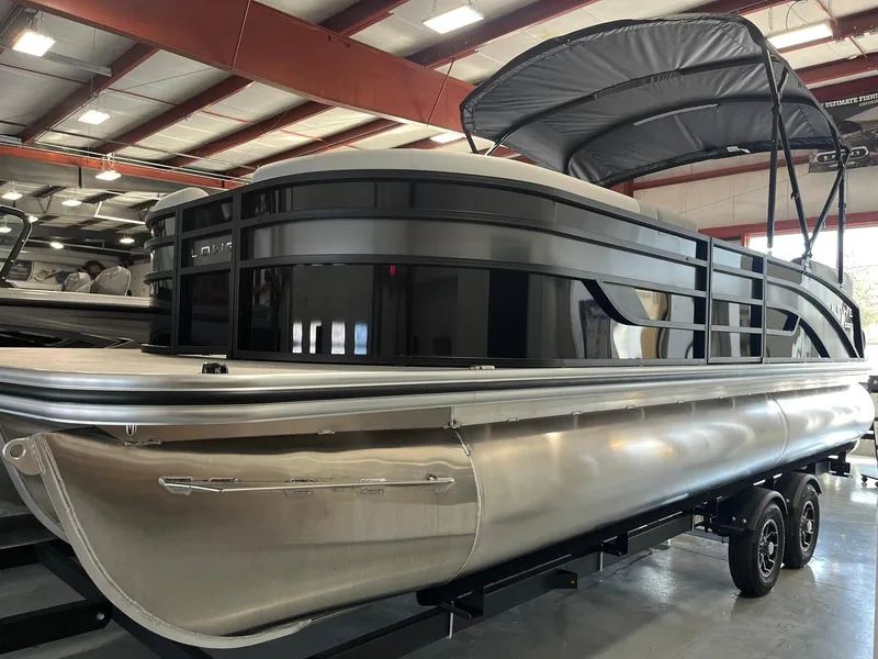 Slide: The Image of 2025 Lowe SS 230 WV pontoon boat in showroom with canopy and sleek design. - 25