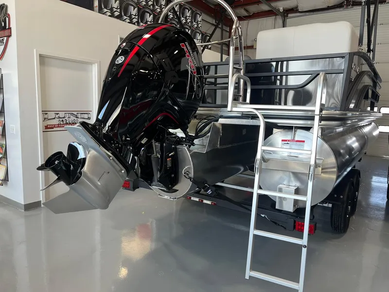 Slide: The Image of 2025 Lowe SS 230 WV pontoon boat with powerful outboard motor in showroom. - 3