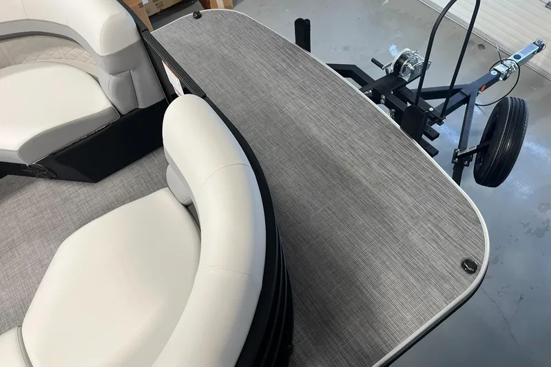 Slide: The Image of 2025 Lowe SS 230 WV boat interior with plush seating and trailer attachment. - 5