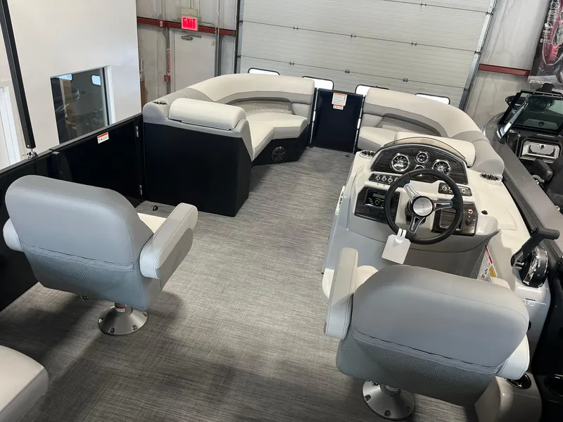 Slide: The Image of Interior of 2025 Lowe SS 230 WV pontoon boat with modern seating and steering console. - 6