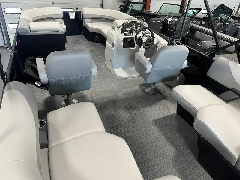 Slide: The Image of 2025 Lowe SS 230 WV pontoon boat interior with plush seating and modern helm. - 8