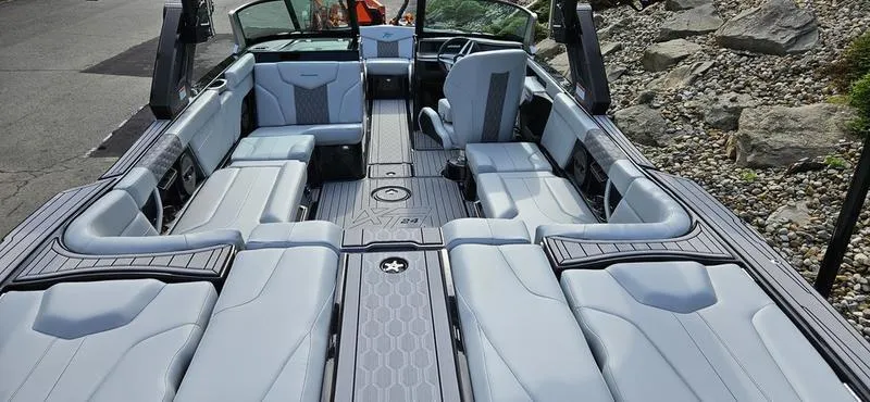 Slide: The Image of 2025 MasterCraft XT24 boat interior with luxurious seating and modern design. - 11