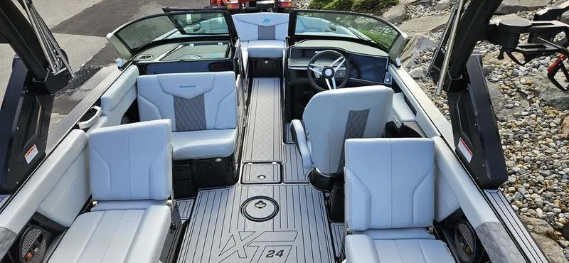 Slide: The Image of 2025 MasterCraft XT24 boat interior with luxurious seating and modern design. - 12