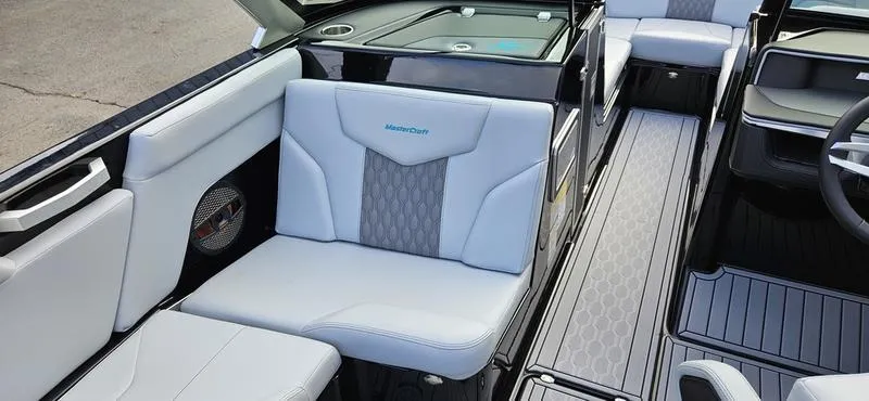 Slide: The Image of 2025 MasterCraft XT24 boat interior with sleek gray seating and modern design. - 13