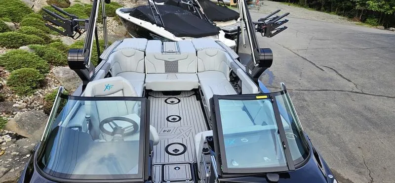 Slide: The Image of 2025 MasterCraft XT24 boat with sleek design and spacious seating. - 15