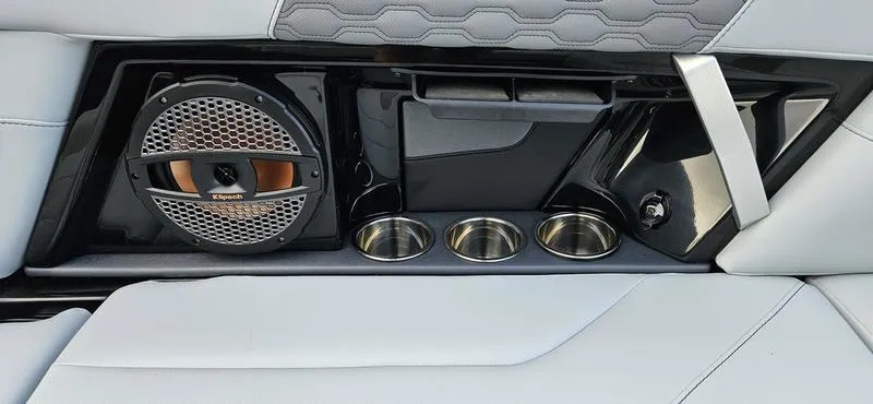 Slide: The Image of 2025 MasterCraft XT24 interior with speaker, cup holders, and sleek design. - 17