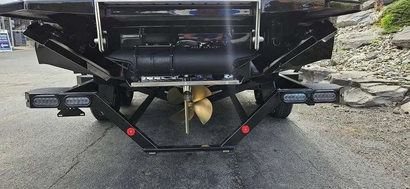 Slide: The Image of 2025 MasterCraft XT24 boat trailer with propeller and lights. - 20