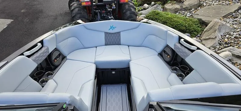 Slide: The Image of 2025 MasterCraft XT24 boat interior with luxurious seating and cup holders. - 4