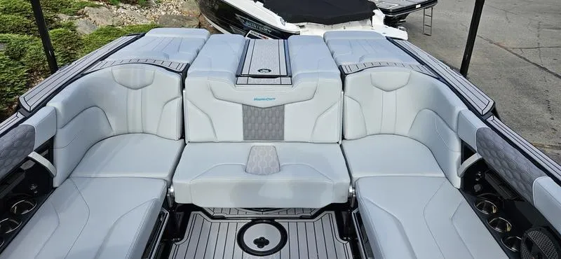 Slide: The Image of 2025 MasterCraft XT24 boat interior with luxurious seating and modern design. - 5