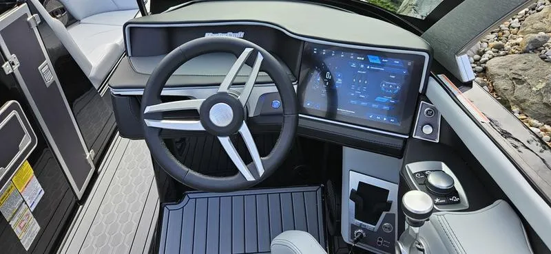 Slide: The Image of 2025 MasterCraft XT24 boat dashboard with modern steering and touchscreen controls. - 6