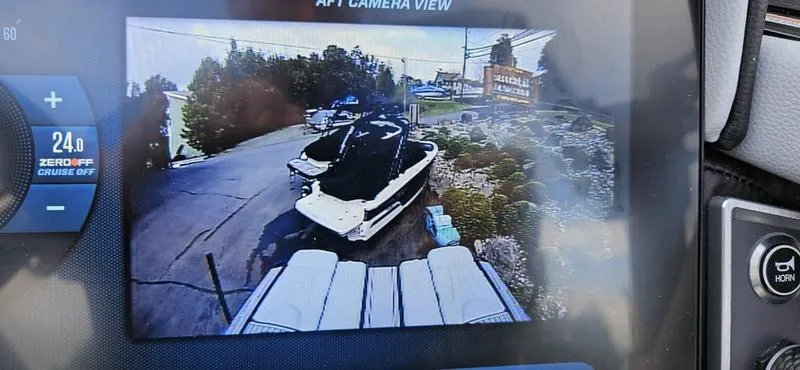 Slide: The Image of 2025 MasterCraft XT24 boat on trailer, viewed through rear camera display. - 9
