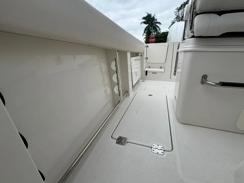 Slide: The Image of 2025 Sailfish 272 CC boat interior with white seating and storage compartments. - 15