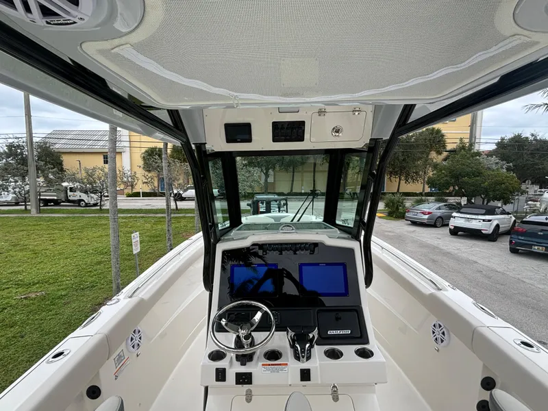Slide: The Image of 2025 Sailfish 272 CC boat cockpit with modern navigation system and steering wheel. - 17